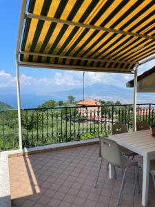 patio ze stołem i krzesłami na balkonie w obiekcie Villa Marilù w mieście Pimonte