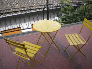 a table and two chairs and a yellow table and chairs at Casa Fantasy Alloggio Turistico in Tuscania