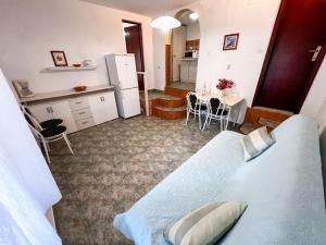 a room with a bed and a kitchen with a table at Robinson Ina 1 in Gdinj
