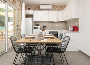 a kitchen with a table and chairs in a kitchen at Villa Maria in Laganas