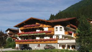 a building with flowers on the side of it at Alpenpension Pfurtscheller in Neustift im Stubaital