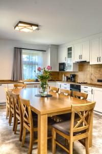 a kitchen with a wooden table and chairs at Gray Wings Home 