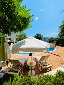 a group of chairs and a table and a tent at Sineva Del Sol Apartments in Sveti Vlas