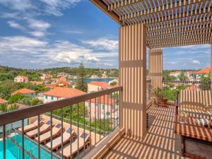 a balcony with a view of a resort at Fiscardo Bay Hotel in Fiskardo