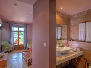 a bathroom with a sink and a mirror at Fiscardo Bay Hotel in Fiskardo