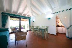 a living room with a table and chairs at Villa Camilla in Stintino