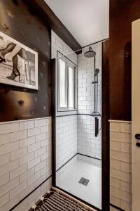 a bathroom with a shower with a glass door at Ático Centro de Madrid in Madrid