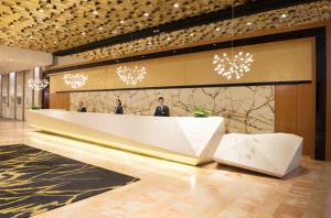 a lobby with people standing at a reception desk at Leonardo Plaza Hotel Jerusalem in Jerusalem