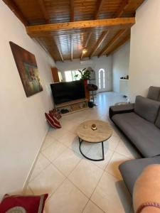 ein Wohnzimmer mit einem Sofa und einem Tisch in der Unterkunft Oasi in Salamís