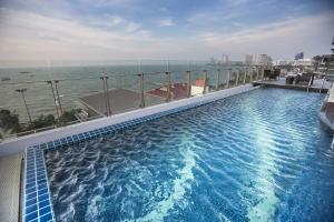 a large swimming pool on the roof of a building at Serenotel Pattaya in Pattaya