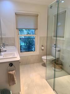 a bathroom with a sink and a toilet and a window at The Birches Beechworth in Beechworth