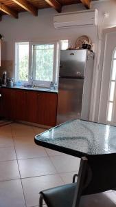 a kitchen with a stainless steel refrigerator and a table at Oasi in Salamina