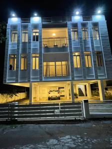 a car parked in front of a building at night at BMRAN Luxury serviced apartment in Cochin