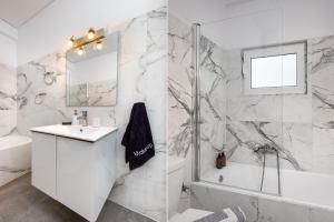 Secret Aktis by BluPine في أثينا: حمام أبيض مع حوض ودش