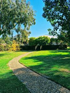 a gravel path in a grassy yard with a house at The Birches Beechworth in Beechworth