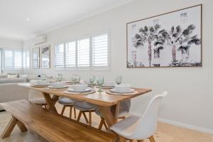 a dining room with a wooden table and chairs at The Haven on Blue Bay in Mandurah