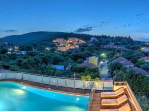 a house with a swimming pool at night at Fiscardo Bay Hotel in Fiskardo