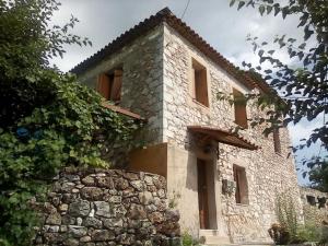 a stone house with a stone wall at Traditional stone build private studio in Verga Kalamata