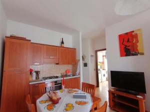 a small kitchen with a table and a television at Centro 44 in Viterbo +6 photos
