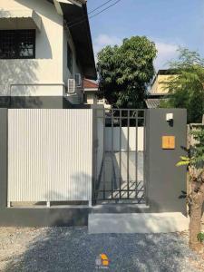 a white gate in front of a house at Arasa House by G Living -6mins MRT Klong Bang Phai in Ban Khung Taphao