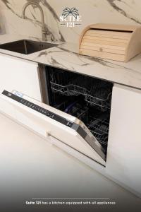 a dishwasher with its door open in a kitchen at Suite 121 - San Pietro in Durrës