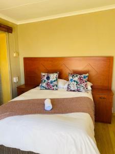 a bedroom with a large bed with two pillows at Mercy Land Guesthouse in Matatiele