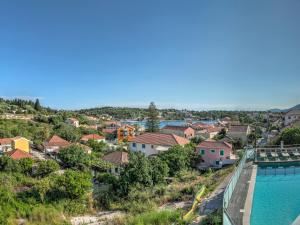 a view of a town with a swimming pool at Fiscardo Bay Hotel in Fiskardo