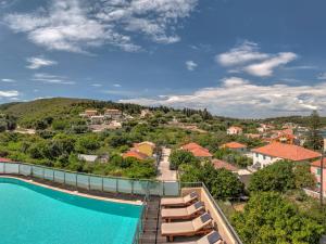 a view of a resort with a pool and lounge chairs at Fiscardo Bay Hotel in Fiskardo