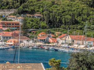 a town with boats docked in a body of water at Fiscardo Bay Hotel in Fiskardo