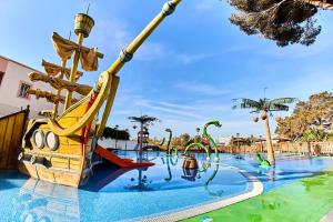 a water park with a pirate ship and slides at Leonardo Royal Hotel Ibiza Santa Eulalia in Es Cana