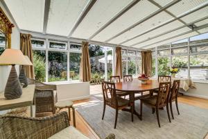 a living room with a table and chairs at High Trees Blenheim View in Woodstock