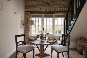 a dining room with a table and two chairs at The Little Barn in Lower Slaughter
