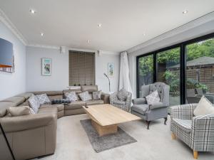 a living room with a couch and chairs and a table at Pass the Keys Prestigious 5 Bed Retreat Spacious Tranquil Haven in Radlett