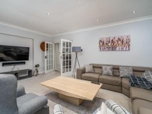 a living room with a couch and a coffee table at Pass the Keys Prestigious 5 Bed Retreat Spacious Tranquil Haven in Radlett