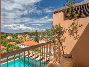 a balcony with a view of a resort at Fiscardo Bay Hotel in Fiskardo