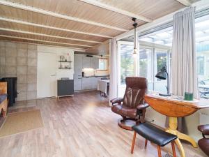 een woonkamer met een bureau en een stoel bij 5 person holiday home in Eskebjerg in Eskebjerg