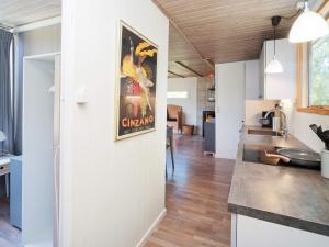 een keuken en een woonkamer met een schilderij aan de muur bij 5 person holiday home in Eskebjerg in Eskebjerg