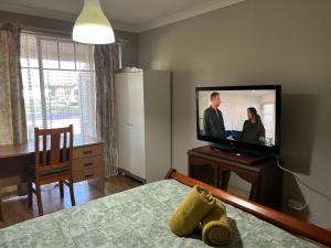 a bedroom with a flat screen tv and a bed at Nice house in canning vale in Perth