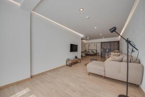 a living room with a couch and a tv at Olive Villas Beach Hotel in Sozopol