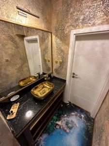 a bathroom with two sinks and a mirror at Robevski luxury rooms in Bitola
