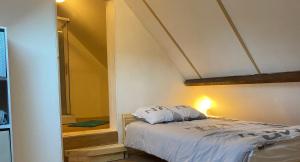 a bedroom with a bed in the corner of a room at Peyranère in Urdos