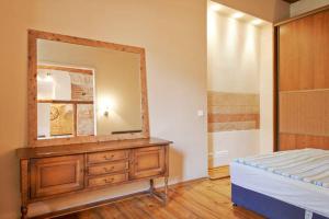 a bedroom with a dresser with a mirror on it at Mykolo Apartments in Vilnius