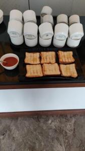 a tray filled with food and bowls of sauce at Blossom residency By Dolphin 500 Mtr Taj mahal in Agra
