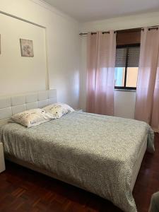 a bedroom with a bed and a window at Amazing Apartments in Agualva