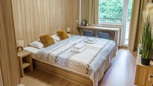 a bedroom with a bed and a large window at Hotel Garni in Považská Bystrica