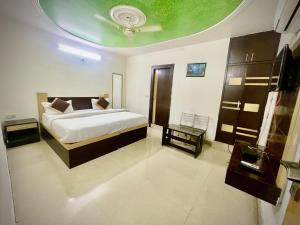 a bedroom with a bed and a ceiling at Blossom residency By Dolphin 500 Mtr Taj mahal in Agra