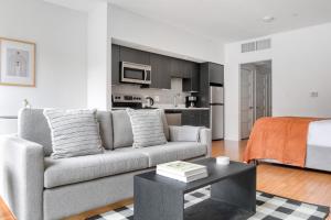 a living room with a couch and a table at Allston Studio w WD Gym nr Green Line BOS-672 in Boston