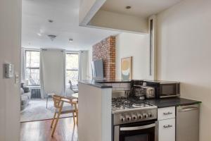 a kitchen with a stove and a microwave at East Village 1br w wd nr First Park NYC-1035 in New York