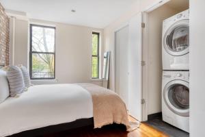 a bedroom with a bed and a washer and dryer at East Village 1br w wd nr First Park NYC-1035 in New York