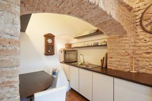 a kitchen with a counter and a brick wall at Mykolo Apartments in Vilnius